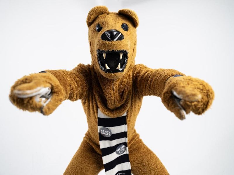 The Nittany Lion mascot points to the camera with both hands